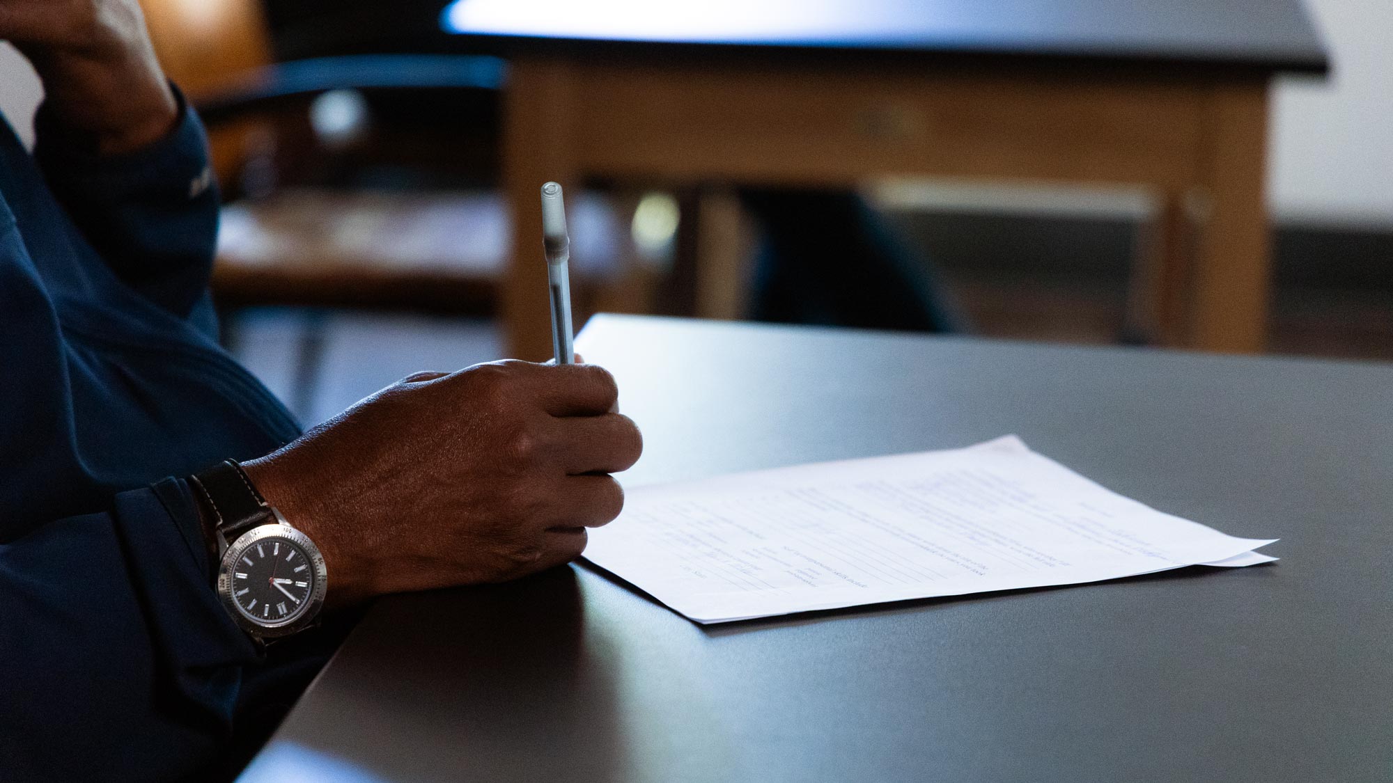 A close up of someone writing on a piece of paper