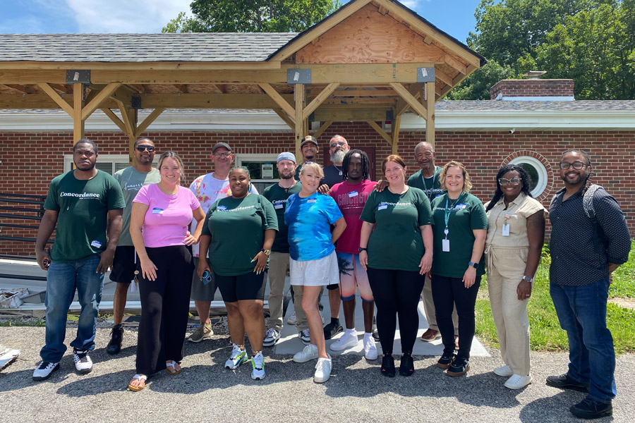 A group of people stand together for a photo.