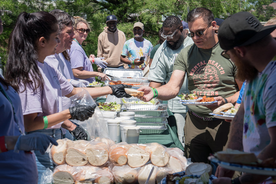 Concordance workers hand out food in a buffet line.