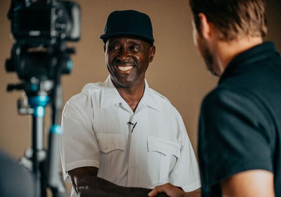 A man smiling in front of a camera